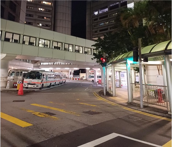 The image titled "An Exterior Photograph of the Entrance to Queen Mary Hospital Taken at 11 PM" shows the hospital’s main entrance at night, with the quiet, illuminated street and building. This photograph captures a significant moment from the author's surgical elective experience at Queen Mary Hospital in Hong Kong. It highlights the long hours spent in surgery, including a memorable 13-hour operation, reflecting the dedication required in the medical field, as described in the article​.